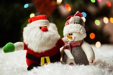 Santa claus and snowman on snow