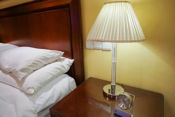 bright vintage lamp at bedside in bedroom