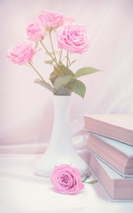 Roses and old book. Toned image
