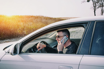 Smiling Man Speak on Smart Phone in White Car