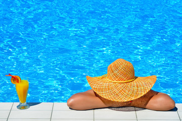 Real female beauty relaxing at swimming pool