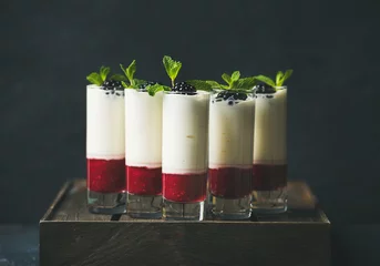 Gordijnen Catering, banquet or party food concept. Dessert in glass with blackberries and mint leaves over dark background on corporate event, christmas, birthday, wedding celebration, selective focus © sonyakamoz