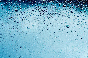 Rainy wet cold blue sky eco seasonal natural background with water drops