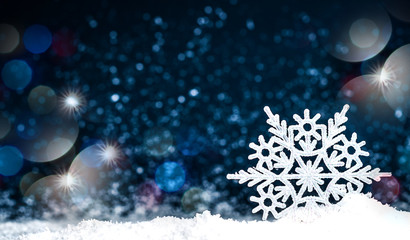 Snowflake in the snow on a dark blue background
