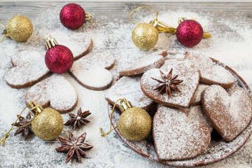 Fototapeta na wymiar Christmas heart shaped cookies with sugar powder. Christmas decoration.