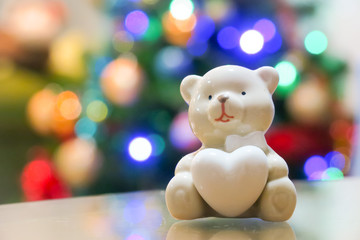 Christmas bear decoration and christmas tree lighting blur background