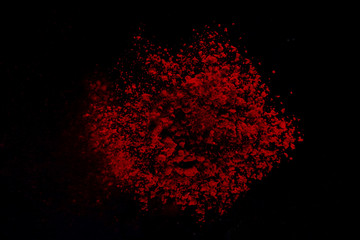 Red colorful powder splash isolated on black background