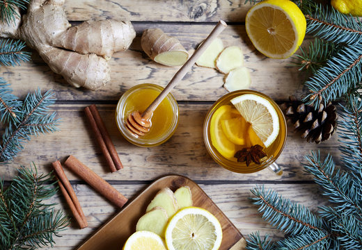 Cup of green natural ginger tea with lemon and honey on wooden rustic background. Healthy drink. Hot winter beverage concept.