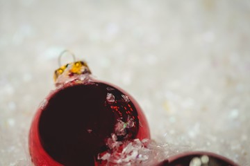 Close-up of christmas baubles on snow