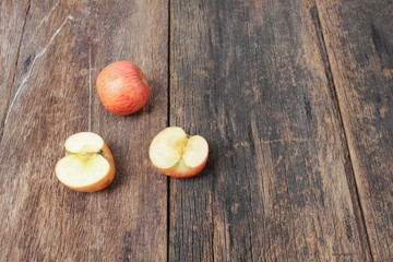 red apple and slice on wooden background, top view 