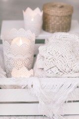 Cozy wool winter accessory. Warm sweaters candle and wood tray