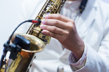 Fototapeta premium Hands of musicians who are blowing the saxophone.