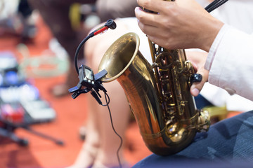 Fototapeta premium Hands of musicians who are blowing the saxophone.