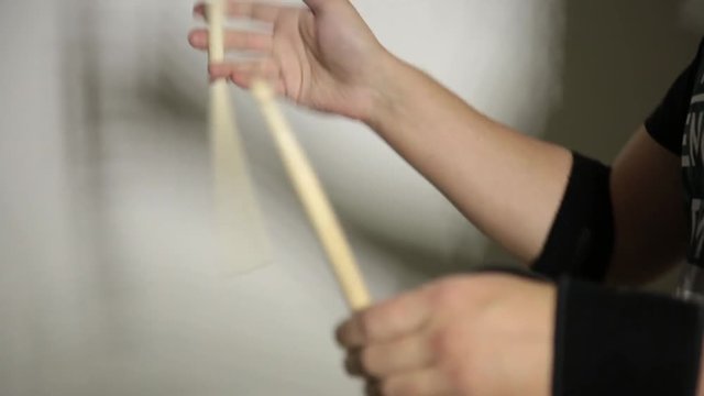 close-up hands of expressive young drummer with drum stick