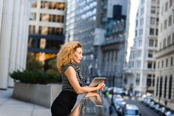 Young businesswoman working on the tablet outdoor