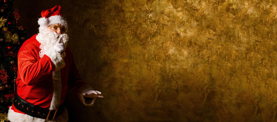 Santa Claus with finger on lips asking for silence