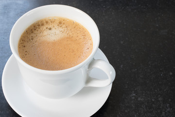 Obraz na płótnie Canvas Cup of espresso coffee with foam isolated on dark background.