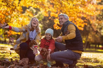 Joyful family at park during autumn
