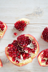 pomegranate seeds on wooden surface