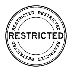 Grunge black restricted round rubber stamp on white background