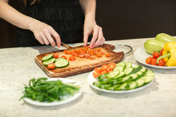 Woman's hands cutting vegetables.