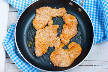 Raw turkey breast fillet in breadcrumbs