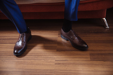 Business man dressing up with classic, elegant shoes. Groom wearing on wedding day, tying the laces and preparing.