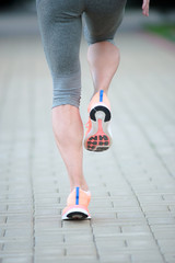 Athlete runner feet running on road closeup on shoe. woman fitne