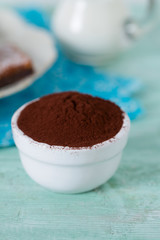 cocoa powder and brownies on background
