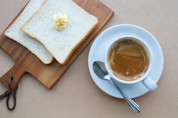 Coffee and toast and butter with copy space. top view.
