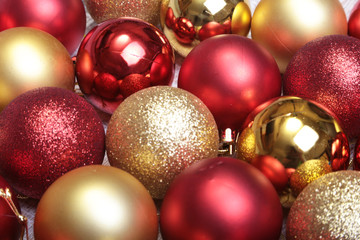 Red and gold christmas balls on a wooden background