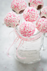 white and pink cake pops in mason jar