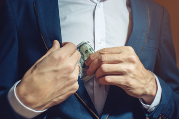 man businessman taking notes in pocket as a bribe