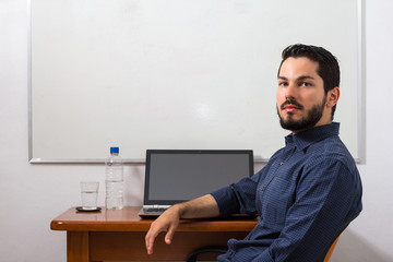 Minimalistc office desk with white board in the back