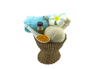 Fototapeta na wymiar Spa herbal compressing ball , white frangipani flower turmeric powder in white spoon massage oil and blue fabric on bamboo basket isolate on white background.Saved with clipping path