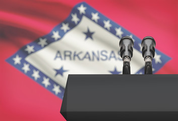 Pulpit and two microphones with USA state flag on background - Arkansas