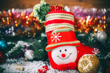 Christmas sock with decor and gifts on a wooden background