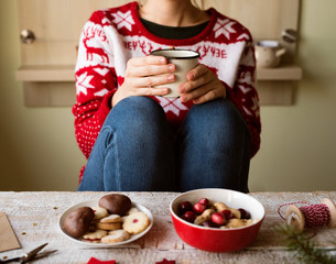 Unrecognizable woman with coffee cup, Christmas composition.