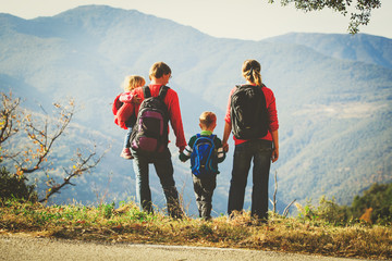 family with two kids hiking in mountains