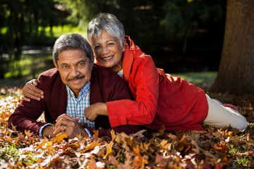 Couple resting on at park during autumn