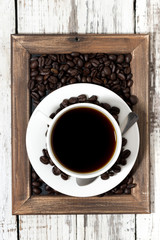 cup of coffee on a wooden tray, vertical top view