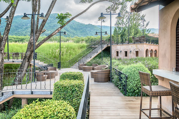 The wood table on natural outdoor of a restaurant with tree and