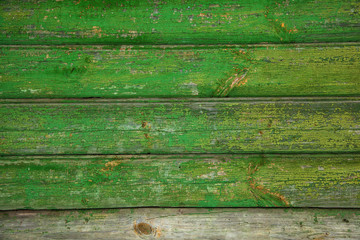 Fototapeta premium Background texture of old wooden wall. Vintage wood surface is naturally aged. Peeling green paint. Grunge background