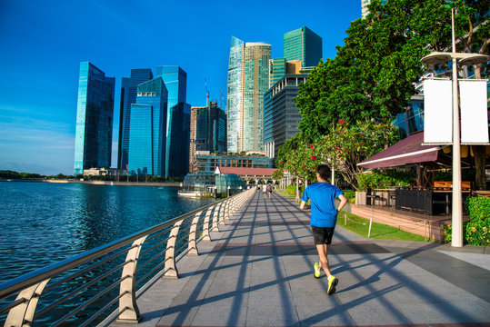 Healthy man running exercise in the morning in Marina Bay Sand park.