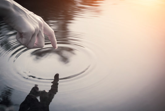 Close Up Finger Touches Water And Drop Of Water Falling And Creating Natural And Calm Waves,calmly Concept,