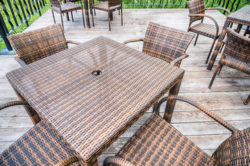 The wood table on natural outdoor of a restaurant with tree and