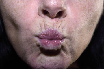 Detail of wrinkled lips of a middle-aged woman, 40-45 years