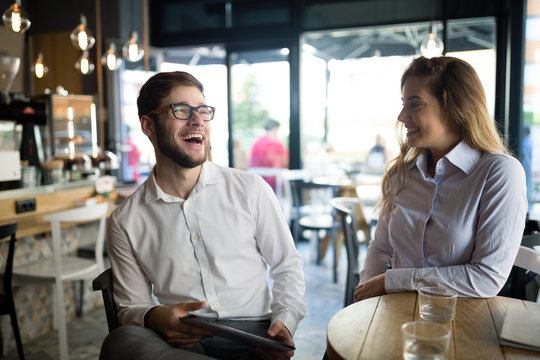Business colleagues dating in restaurant