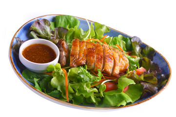 Grilled chicken salad with dressing on white background