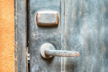 Closeup metal door with lock in grungy style and good texture.
